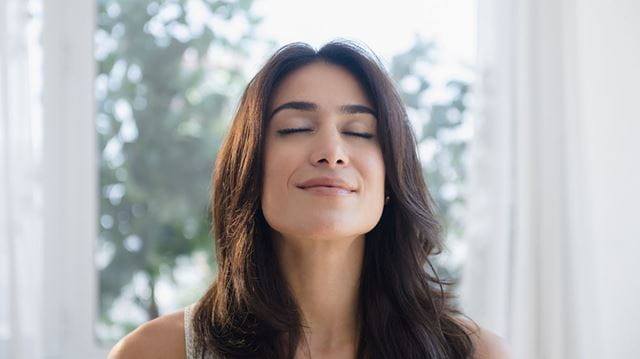 Breathing for mental and physical wellbeing; woman relaxing